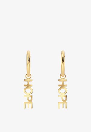 Zelta apli auskari ar izgrieztu vārdu "HOPE" treknā fontā, izceļot gludu, pulētu tekstūru un minimālistisku dizainu.