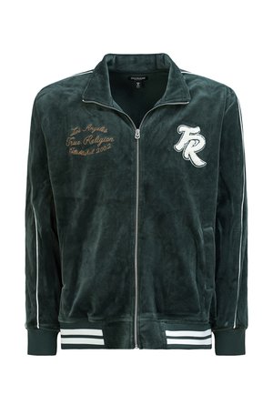 Tummanvihreä vetoketjullinen veluuritrenssitakki, jossa valkoiset raidat, resorit hihansuissa sekä kirjailtu teksti ja logo edessä.