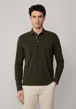 Langarm poloshirt van donkergroene katoen met een klassieke kraag en een driewegknopsluiting. Kenmerkt zich door een subtiele logo op de zoom.