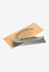 Metallmustaschkam med fina och breda tänder, designad för skötsel. Levereras med ett brunt kortfodral med svart tryckt text.