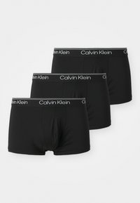 Zwarte boxershorts gemaakt van rekbaar materiaal, met een Calvin Klein-logo tailleband in het wit en een glad oppervlak zonder zichtbare patronen.