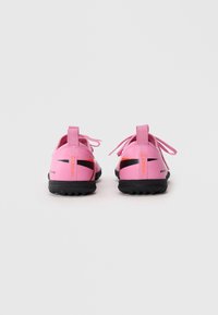 Et par rosa Nike Mercurial fotballsko med svarte såler, sett fra baksiden, isolert på hvit bakgrunn.