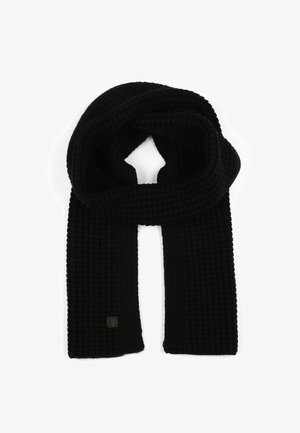 Black knitted scarf featuring a textured ribbed pattern. Includes a small logo patch at one end.