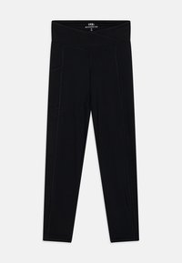 Leggings neri con vita alta, realizzati in tessuto elasticizzato, presentano tasche laterali e cuciture piatte per comfort e durata.