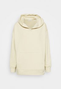Hoodie color crema realizzata in tessuto morbido, con un ampio cappuccio, tasca a marsupio e polsini a coste. Design minimalista senza motivi.