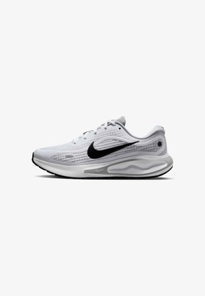 Nike running shoe featuring a light gray mesh upper, black swoosh logo, and white midsole with textured accents and black outsole.