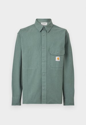 Green button-up long-sleeve shirt with a collar, chest pocket with button flap, and a small Carhartt logo patch on the pocket.