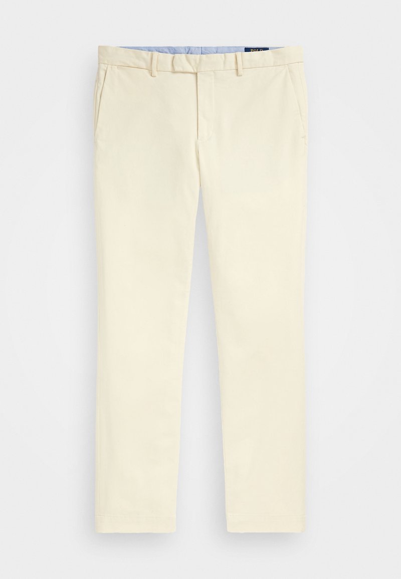 Chinos de couleur crème clair avec une texture lisse, présentant des poches avant, un design à jambe droite et une ceinture intérieure bleue contrastante.