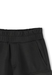Pantalon de survêtement noir avec une taille élastique, doté de poches latérales et d'un tissu texturé. Design simple, adapté à un style décontracté.
