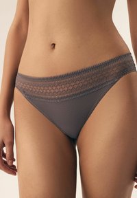 Gray ribbed panties featuring a floral lace band at the waist, offering a soft texture and a snug fit.