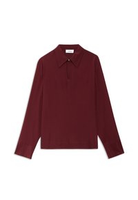 Bordowa bluzka z długim rękawem, z wysmuklającym kołnierzykiem, detalem w kształcie otworu przy szyi i gładką fakturą. Posiada akcenty w postaci guzików na kołnierzu.
