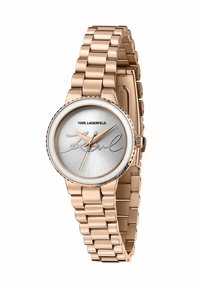 Orologio in oro rosa con cinturino in metallo a maglie, quadrante argentato e dettaglio distintivo. Cassa rotonda con ghiera testurizzata e indici orari semplici.