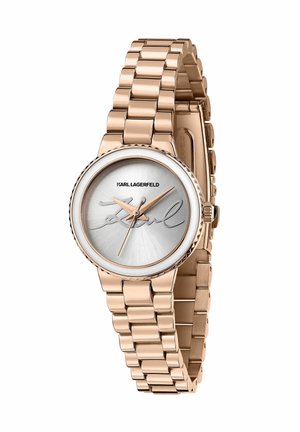 Rosaguldsur med lænket metalarmbånd, der har en sølvfarvet urskive og signaturdetalje. Rund kasse med tekstureret krans og enkle timeindikatorer.