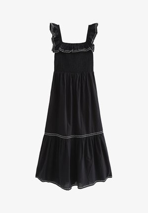Robe midi noire sans manches avec encolure carrée à volants et ourlet, bordure blanche en zigzag sur les volants et les niveaux de la jupe.