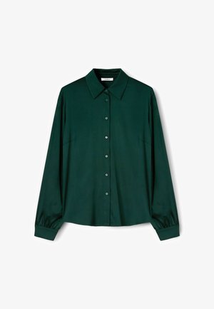 Donkergroen overhemd met lange mouwen, een klassieke kraag en een iets losse pasvorm. Soepele textuur met een knopenlijst aan de voorkant en een enkele zak.