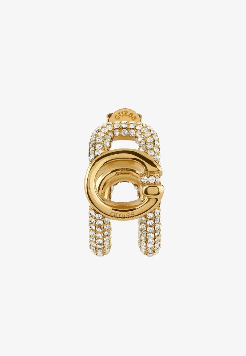 Goldfarbener Anhänger mit einem kreisförmigen Design, besetzt mit klaren Kristallen. Glatte Oberfläche mit strukturierten Akzenten. Markenname oben sichtbar.