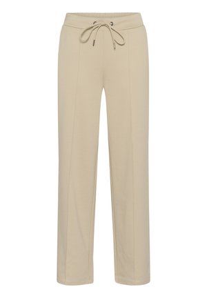 Pantalons de survêtement beiges avec une taille élastique, cordon de serrage ajustable, deux poches avant et des détails de couture verticale. Tissu doux avec une texture lisse.