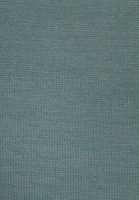 A textured, knit fabric in teal blue, featuring a consistent pattern of intertwined threads that create a subtle depth and softness.