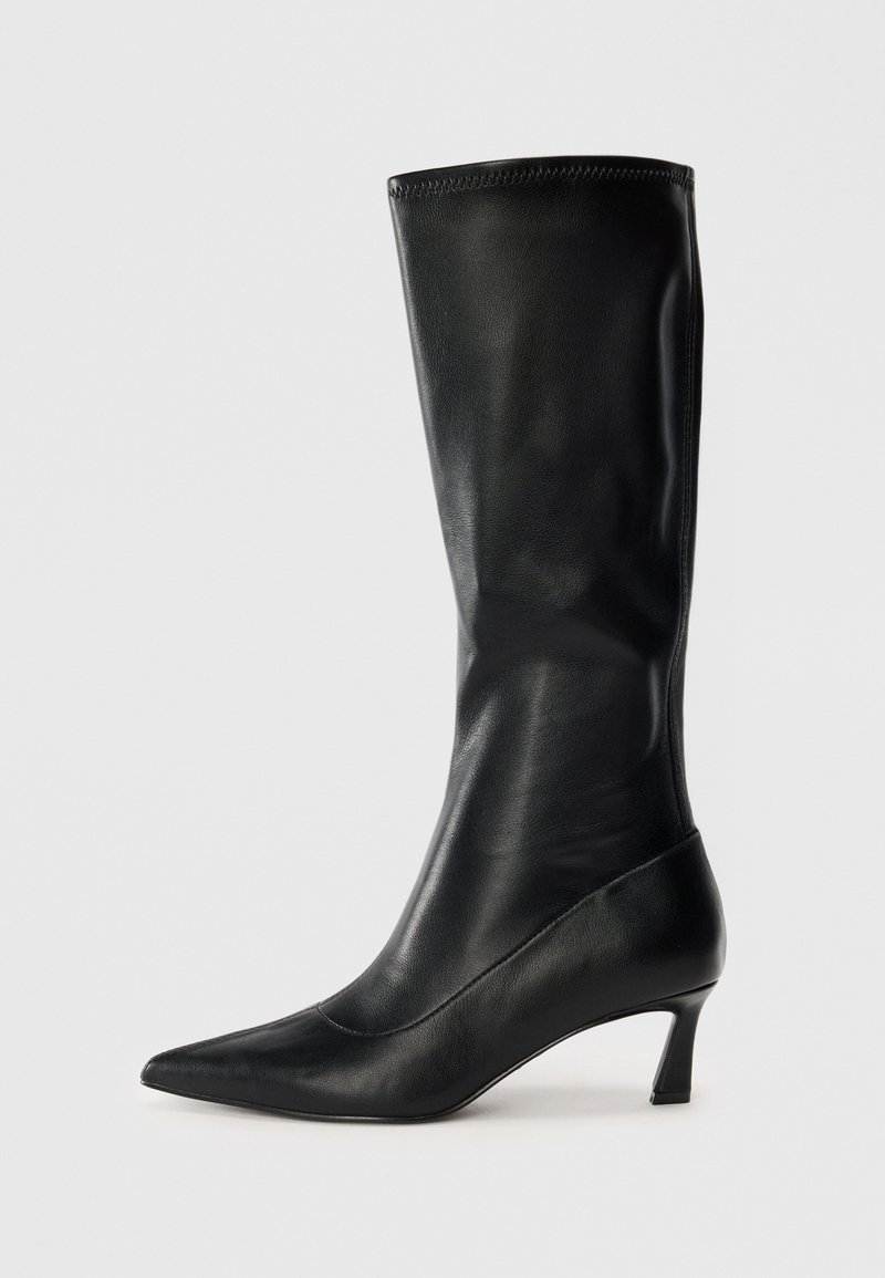Black leather knee-high boot with a pointed toe and a modest heel. Smooth texture and sleek design with subtle stitching details.