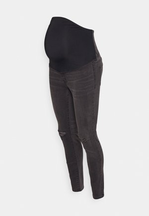 Calças de maternidade pretas com um painel elástico para suporte, apresentando um corte skinny, detalhes rasgados nos joelhos e um acabamento em denim macio.