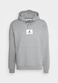 Šedá mikina s kapucí z bavlněné směsi, s přední kapsou, stahovací kapucí a bílou nášivkou s logem zobrazujícím skákající postavu.