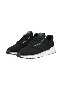 Paire de baskets noires tricotées avec semelles blanches, design à lacets et logo GANT sur le côté et la languette.