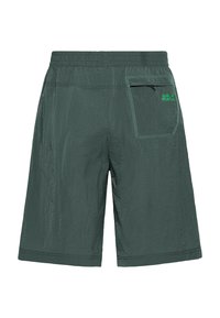Dark green shorts made of lightweight, textured material. Features a back pocket with visible stitching and brand logo in green on the rear.