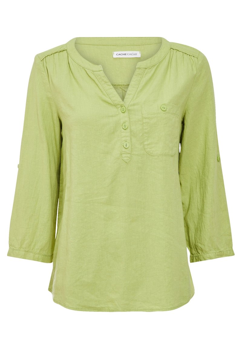 Blouse à manches longues vert clair avec trois boutons sur le plastron avant, une poche poitrine avec bouton, et un col rond.