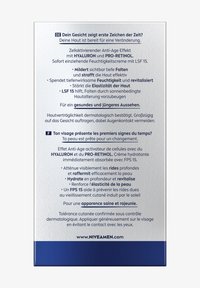 Nivea Men anti-aging cream packaging, silver with blue accents, featuring multilingual text, detailing hydrating and firming benefits.