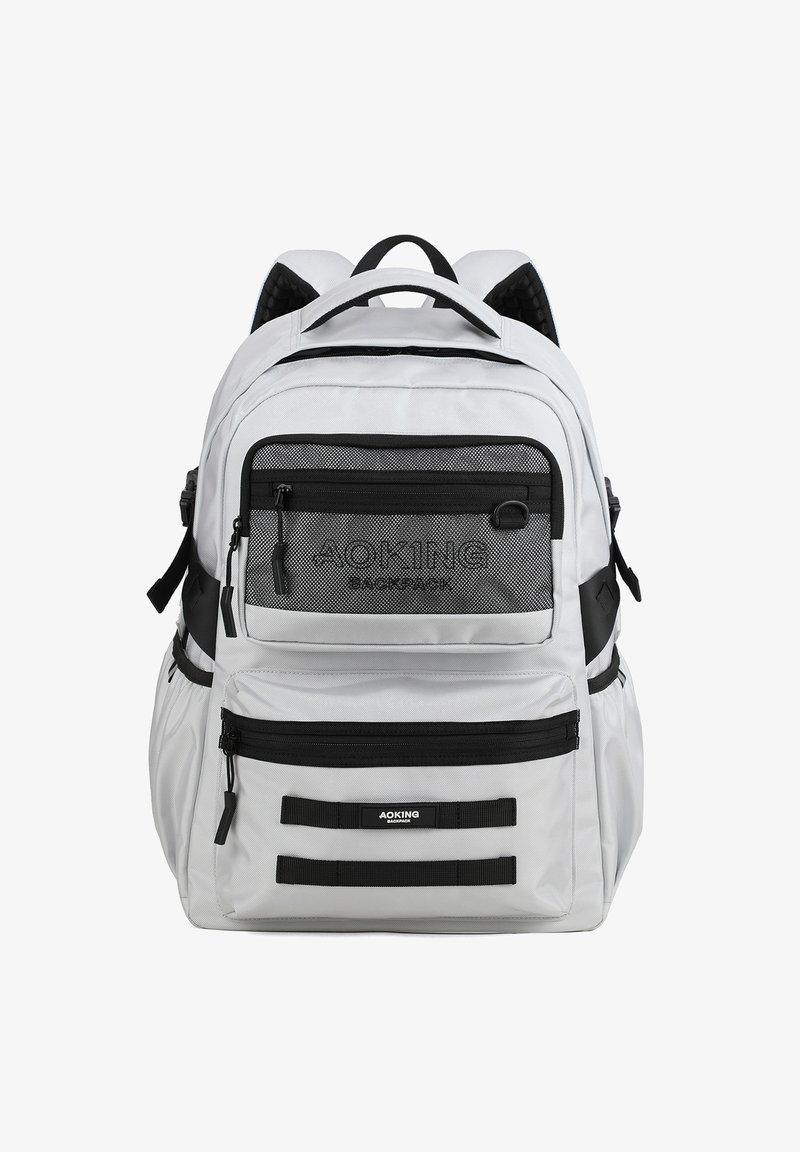 Zaino grigio con accenti neri, multiple tasche con zip, pannello frontale in rete, spalline imbottite e cinghie di compressione laterali.