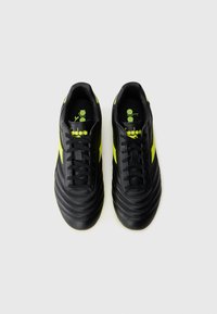 Black soccer shoes with yellow accents, featuring a textured leather upper, padded collar, and a lace-up closure for a secure fit.
