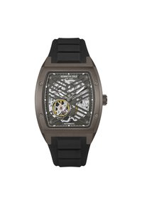Kenneth Cole automatski sat ima prozirni skeleton brojčanik, crnu silikonsku narukvicu i pravokutno sivo kućište s mrežastim detaljima.