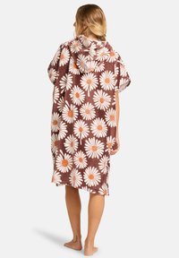 Poncho de playa con capucha en marrón, con margaritas blancas y centros naranjas, textura suave, diseño holgado y dobladillo de longitud media.