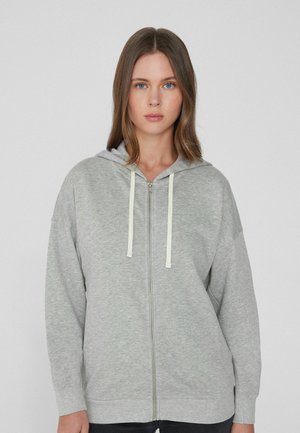 Grauer Reißverschluss-Hoodie aus weichem Stoff mit Kapuze. Verfügt über leichte Kordeln und gerippten Saum. Lockere Passform und lange Ärmel.