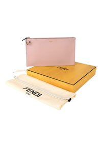 Pochette Fendi rose doux avec fermeture éclair dorée, présentée avec une boîte jaune Fendi et une housse anti-poussière blanche Fendi sur fond blanc.
