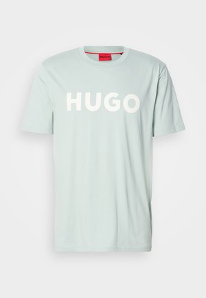 Light blue short-sleeve t-shirt with large white "HUGO" text across the chest and a red label at the collar.