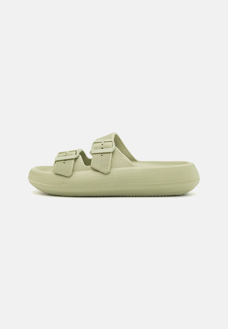 Light green molded slide sandals made of textured material featuring two adjustable buckles on the strap. Flat sole with grip detail.