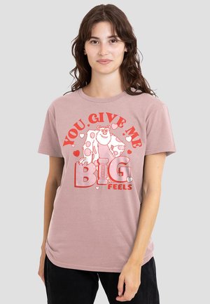 Light pink cotton t-shirt featuring a cartoon design of a monster surrounded by hearts and the text "YOU GIVE ME BIG FEELS" in red.