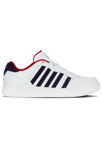 White sneaker featuring a smooth leather upper, navy stripes, red accents on the collar, and a textured rubber sole for grip.