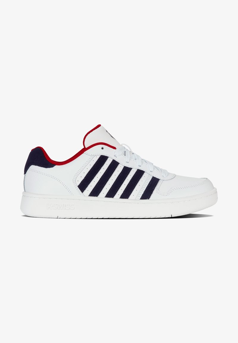 White sneaker featuring a smooth leather upper, navy stripes, red accents on the collar, and a textured rubber sole for grip.
