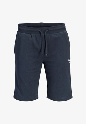Pantalones cortos azul marino con cordón y cintura elástica, con un pequeño logo blanco en el muslo derecho, hechos de tela suave.