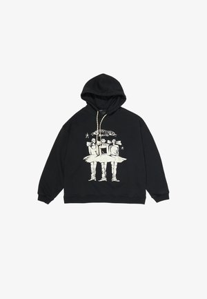 Sweat à capuche noir avec illustration crème de trois danseuses en tutu et grands nœuds, texte au-dessus disant « DANSEUSES. »