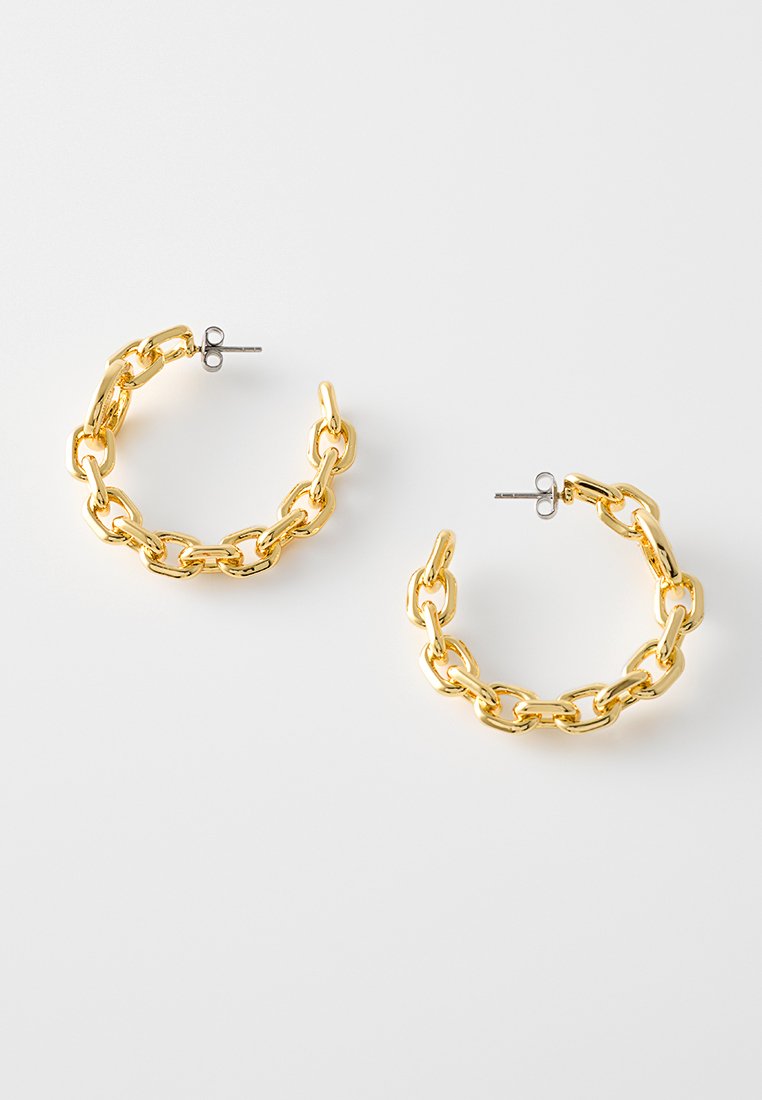 Gouden hoepeloorbellen met een kettinglinkontwerp, glanzend oppervlak en stud post sluiting. Bevat gestructureerde schakels en een gladde afwerking.