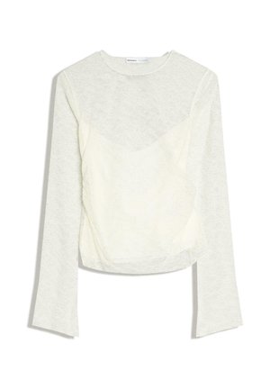 Blouse blanche en dentelle à manches longues avec encolure ronde et silhouette ajustée, dotée d'une doublure intérieure opaque au niveau du torse.