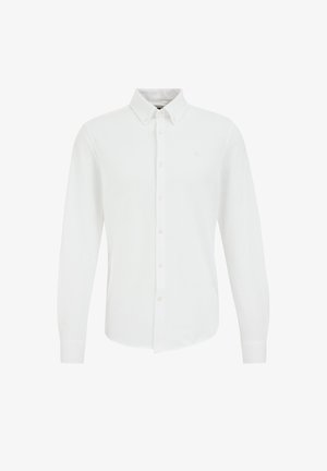 Bijela košulja dugih rukava od glatkog materijala, s ovratnikom na dugme i prednjim kopčanjem na dugmadi. Suptilni logotip na prsima.