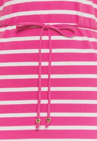 Pink and white striped fabric with an adjustable tie at the waist, featuring gold-accented tips. Soft texture with a relaxed fit design.