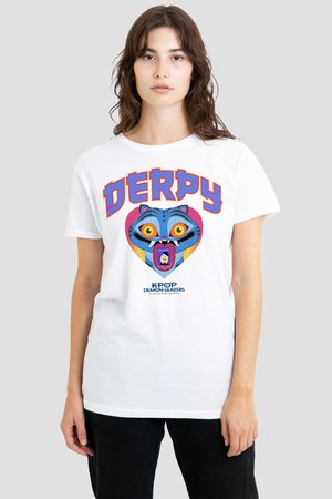 Woman wearing white T-shirt with colorful cartoon blue cat face, large yellow eyes, open mouth, and bold word "DERPY" above, black pants.