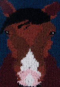 Sweter robiony na drutach z stylizowaną twarzą konia w kolorach brązowym, białym i różowym na niebieskim tle. Projekt zawiera złożone detale teksturalne.