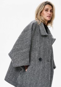 Wollen blend jas met een vissengraatpatroon, oversized mouwen, brede kraag, zwarte knopen en zijzakken in een grijs-wit kleurenschema.