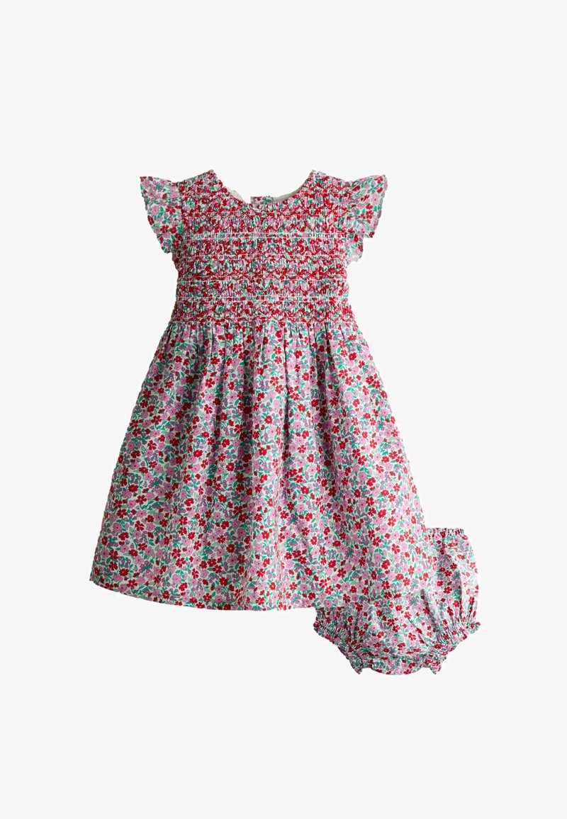 Kvetinové detské šaty s naškrobeným živôtikom a zodpovedajúcimi nohavičkami v červenej, ružovej a zelenej farbe na bielom pozadí.